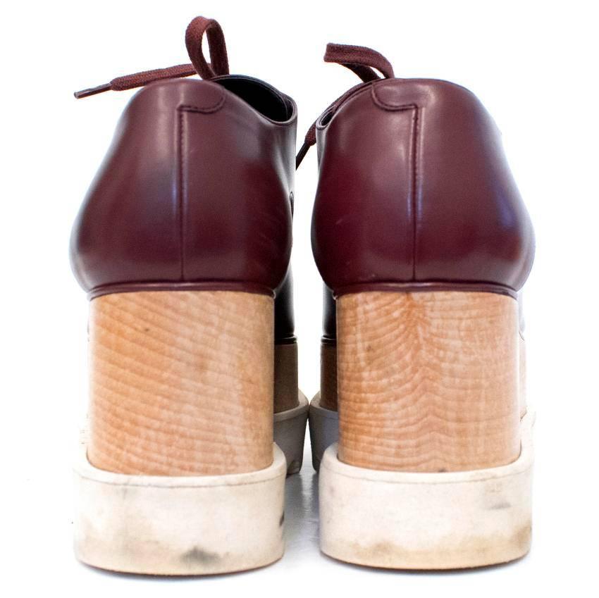 Stella McCartney burgundy Elyse platform derby shoes.
Lace-up square toe platform shoes. Made in Italy.

Conditions Details : Condition - 9/10 
Wear to white rubber sole and very slight wear to toes. Refer to images.


Approx. 
Height: 14.5 Cm