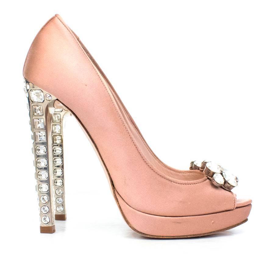 Miu Miu satin blush peep toe pumps.

This item features a crystal embellishment on the peep toe and stiletto heel, with silver hardware.

Approx. 
Length:18cm 
Width:7cm 
Sole:21cm 
Heel:14cm

US size 7
UK size 4
