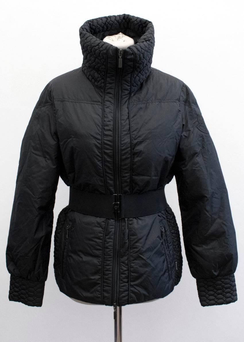Moncler women's black jacket.

The jacket features a quilted high neck collar, with a zip and elasticated belt for closure.

The jacket also holds two large zipped pockets at each side.
Condition:10/10

Approx:
Length:64cm
Sleeve:61cm

UK size 8
US