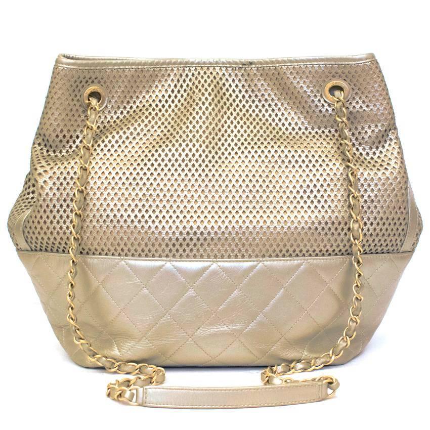 Chanel gold leather shoulder bag.
The bag features a quilted square bottom and gold shoulder chain. 
The bag is closed with a functioning magnetic button with interlocking 'CC' detail. 
There are also three internal pockets.

Please note, these
