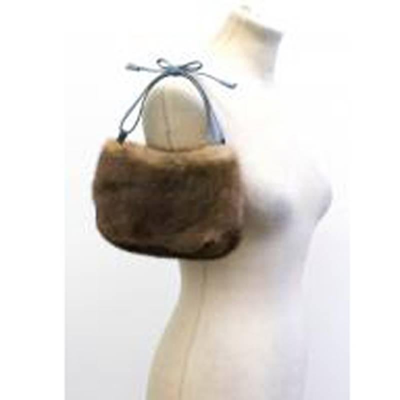 Anya Hindmarch mink fur clutch bag. Features a pale blue tone leather top strap with bow detail and an interior slip pocket. 

Measurements: Approx. Width: 24cm Length: 15cm Depth: 3cm

Condition: 9.5/10

* Please note, these items are pre-owned and