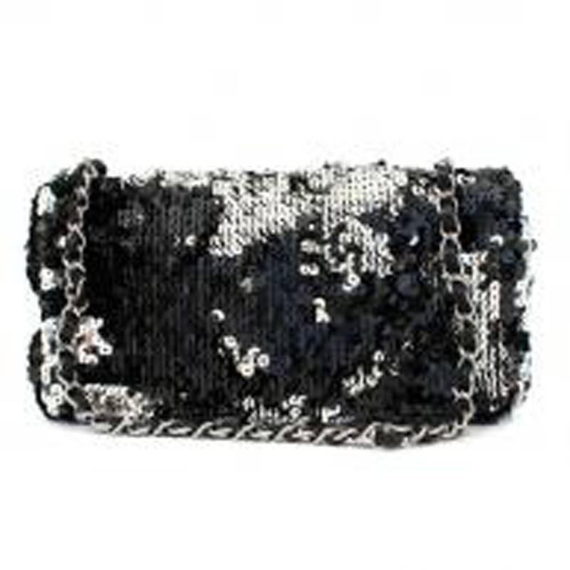 Chanel black sequin flap bag in a foldover style with a single compartment featuring leather and chain shoulder straps.

Measurements: Approx. Handle Drop: 21.5cm Width: 23.5cm Height: 12.5cm Depth: 5.5cm

Condition: 9.5/10

Please note, these items