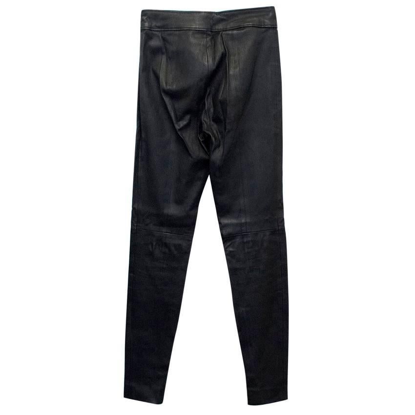 Givenchy black, leather, slim fit, high waist trousers. Trousers have a zip on a side and at the bottom and leather triangle inserts at the front.
This garment belongs to Caroline Stanbury of 'Ladies of London'. 

Size: US 4
Measurements: Approx: