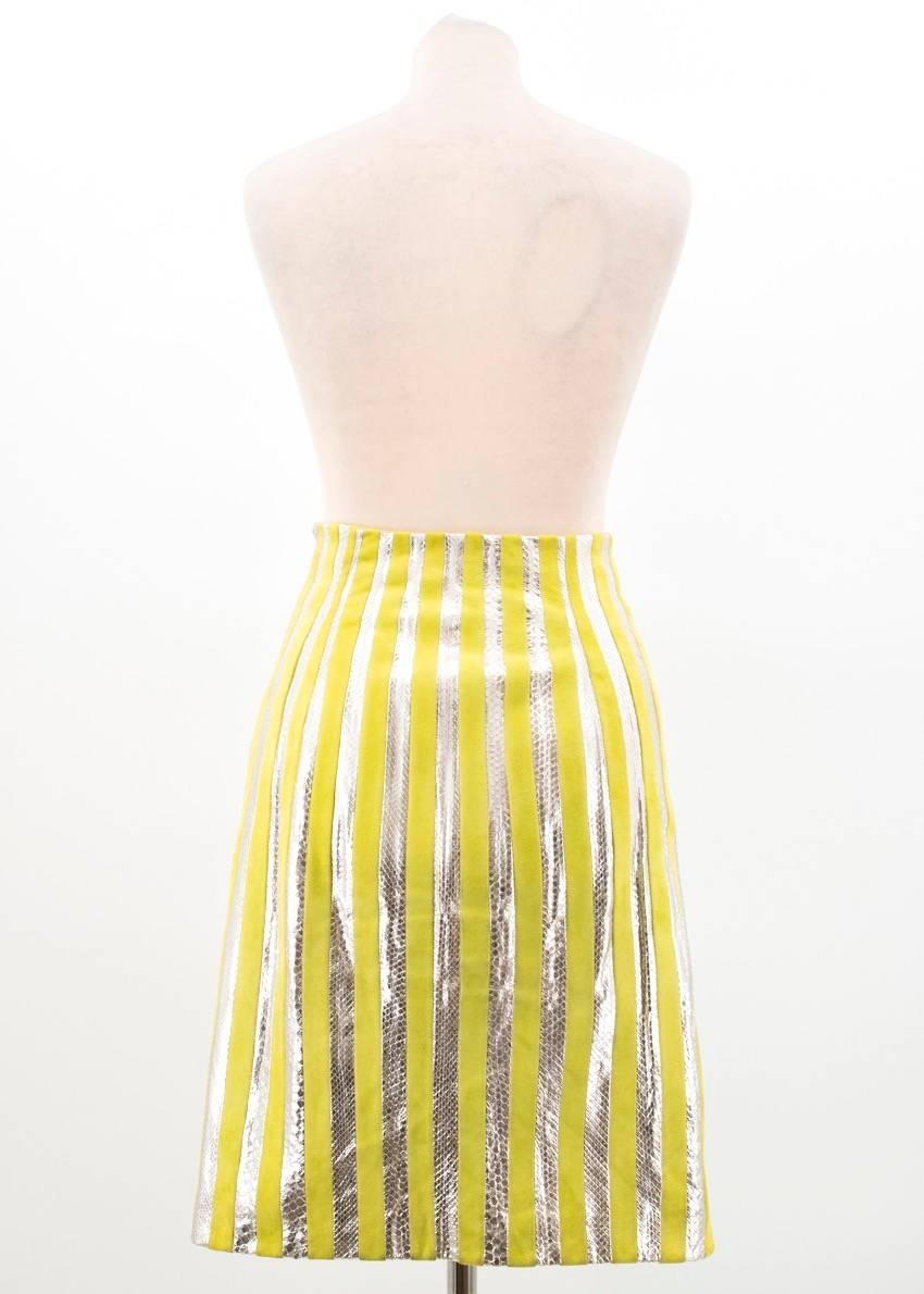 Prada lime green and silver python striped skirt. Fitted. Enclosed zipper down the side with a hook and eye fastening. Comes with the original garment bag.

Conditions Details : Condition: 9.5/10

Minor wear to the waist lining and the hem.

Please