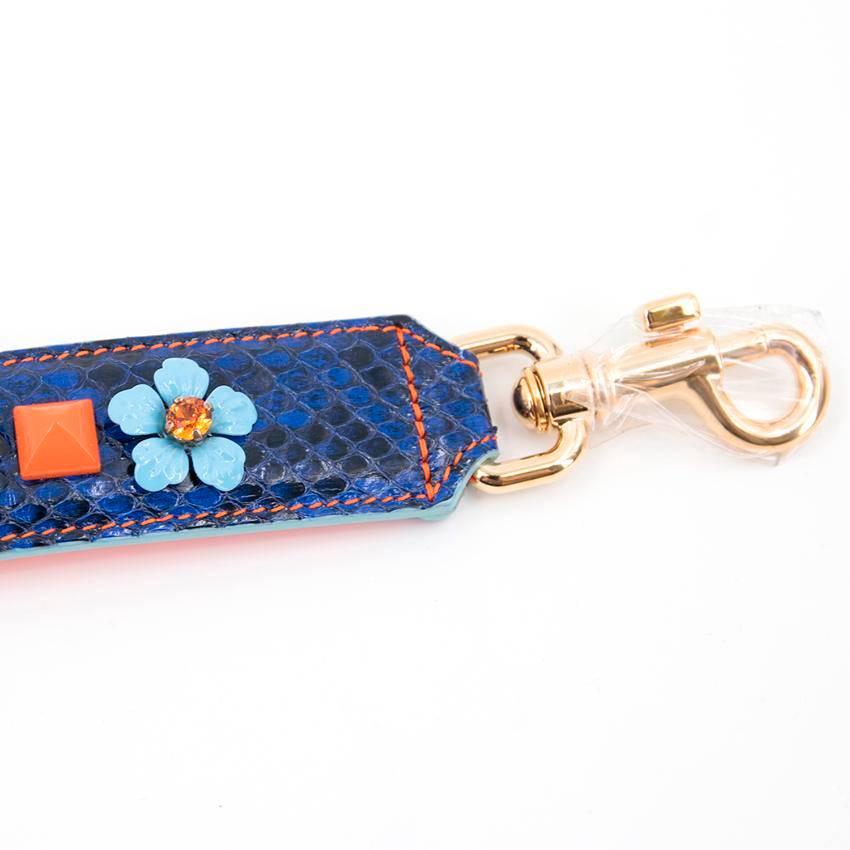 Dolce & Gabbana blue embellished strap. 

Blue snakeskin print leather strap with orange and light blue embellishments. Features contrasting orange leather lining and gold tone hardware. Made in Italy. 

Condition - 10/10

Approx.
 Length: 58 Cm