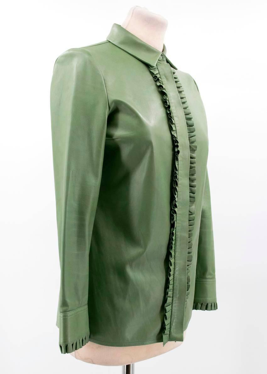 Gucci green leather top. 

Button-down top in soft green leather featuring frilled detailing. Made in Italy. 

Conditions Details : Condition - 9/10 

Some minor marks and signs of wear to leather. 

Please note, these items are pre-owned and may