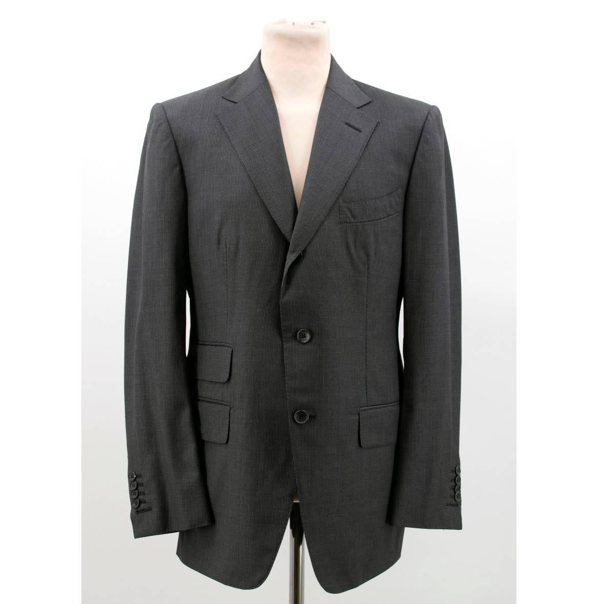 Tom Ford grey stripe suit in a tailored, single-breasted self stripe style. The jacket features 3 front flap pockets and a chest pocket. The slim-fit trousers featured turn-ups and buckle detail at the waistband.

Size: XL
Measurements: Approx.