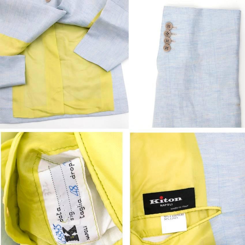 Kiton men's light blue suit. Notch lapels. Three button closure. One pocket on the left chest. Two flap pockets on the waist. Four button closure on each cuff. Lightly checked detail with yellow threading. 

Straight leg trousers. Zip fly with two