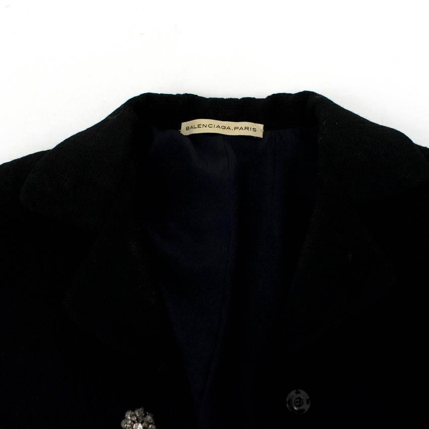 Balenciaga black jacket, with diamanté flower shaped popper buttons in a cropped fit with collar and long sleeves.

Size: US 0-2
Measurements: Approx. Length: 46cm Sleeve: 49cm
Conditions Details: 9.5/10

* Please note, these items are pre-owned and