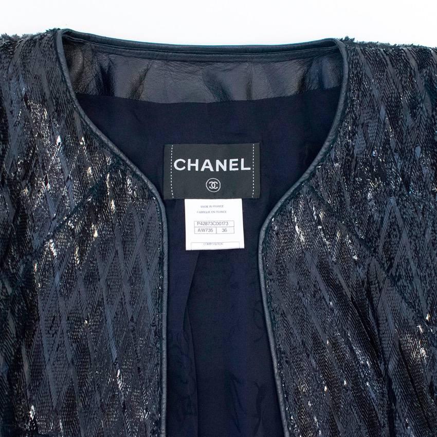 Chanel navy blue, lambskin jacket with a textured sparkly finish and shoulder pads, black crystal embellished buttons, a vent in the back and floral patterned silk lining. 

This item is owned my Caroline Stanbury from 