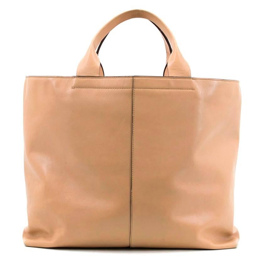 Reed Krakoff tan track shopper tote bag. Soft leather. Two top handles. One dark grey strip down the front. Light pink soft leather interior. Two magnetic fastened compartments inside. 

Measurements: Approx. Width: 50.5cm Height: 33cm Depth: 13cm