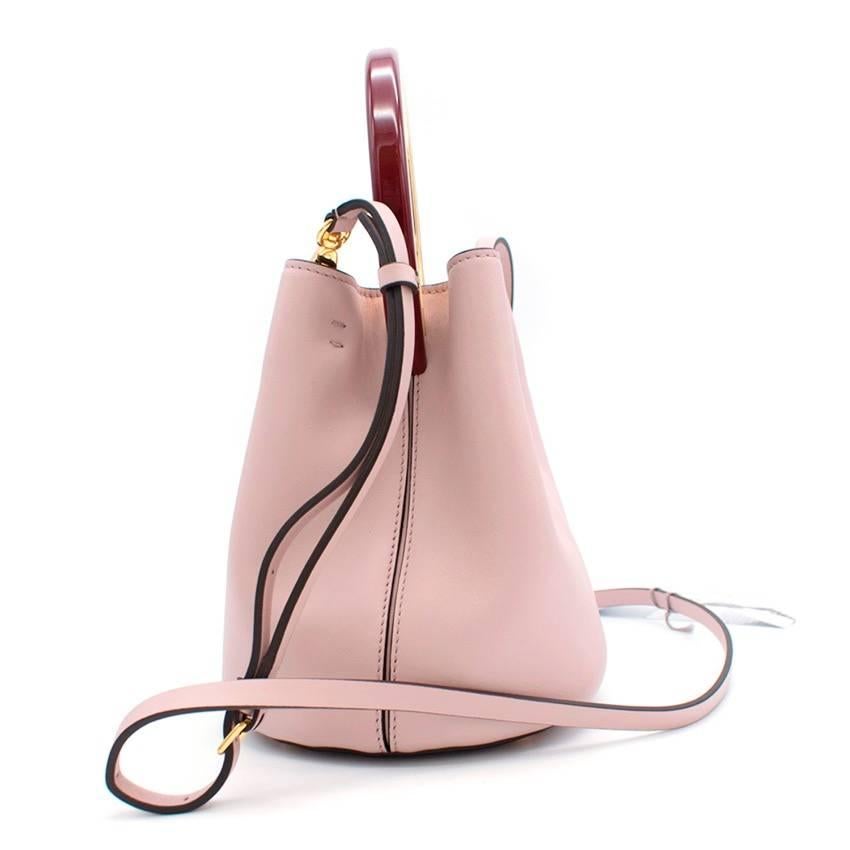 Marni pink Pannier bucket bag in calf leather with gold-tone hardware and enamel top handle. Comes with a detachable shoulder strap, an attached leather pouch and lined with grey suede.

Measurements: Approx. Height - 19cm Width - 16cm Depth - 14cm