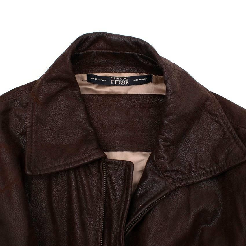 Gianfranco Ferre brown leather jacket in a zipped style with elasticated gathered sleeve detail, two front pockets and gold-tone metal badges. The jacket also features an elasticated gathered back and button detail on the cuffs. 

Size: US