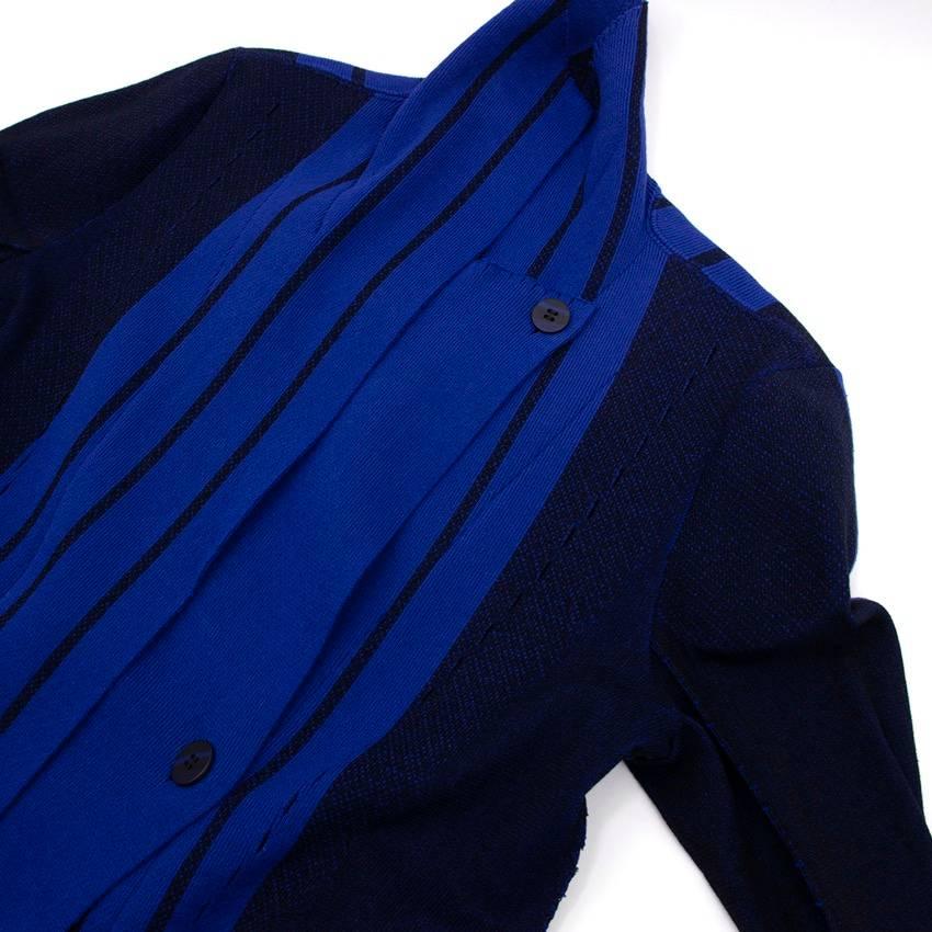 Issey Miyake knit cardigan in royal blue with darker blue panels and stripes. In an asymmetric, button-up longline style with perforated detail and raw edges.

Size: XS
Measurements: Approx. Length - 77cm Sleeve - 45cm Bust - 52cm Waist -