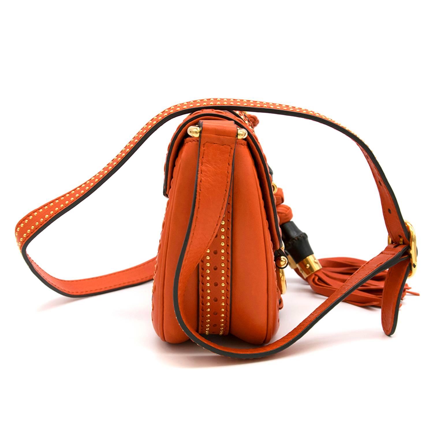 Gucci orange leather mini 'Snaffle Bit' handbag. Top handle with hanging bamboo and knot details, woven panels to the main body of the bag and the edges with gold studs. Gold tone detail on the front on the flap with concealed fastening. Interior