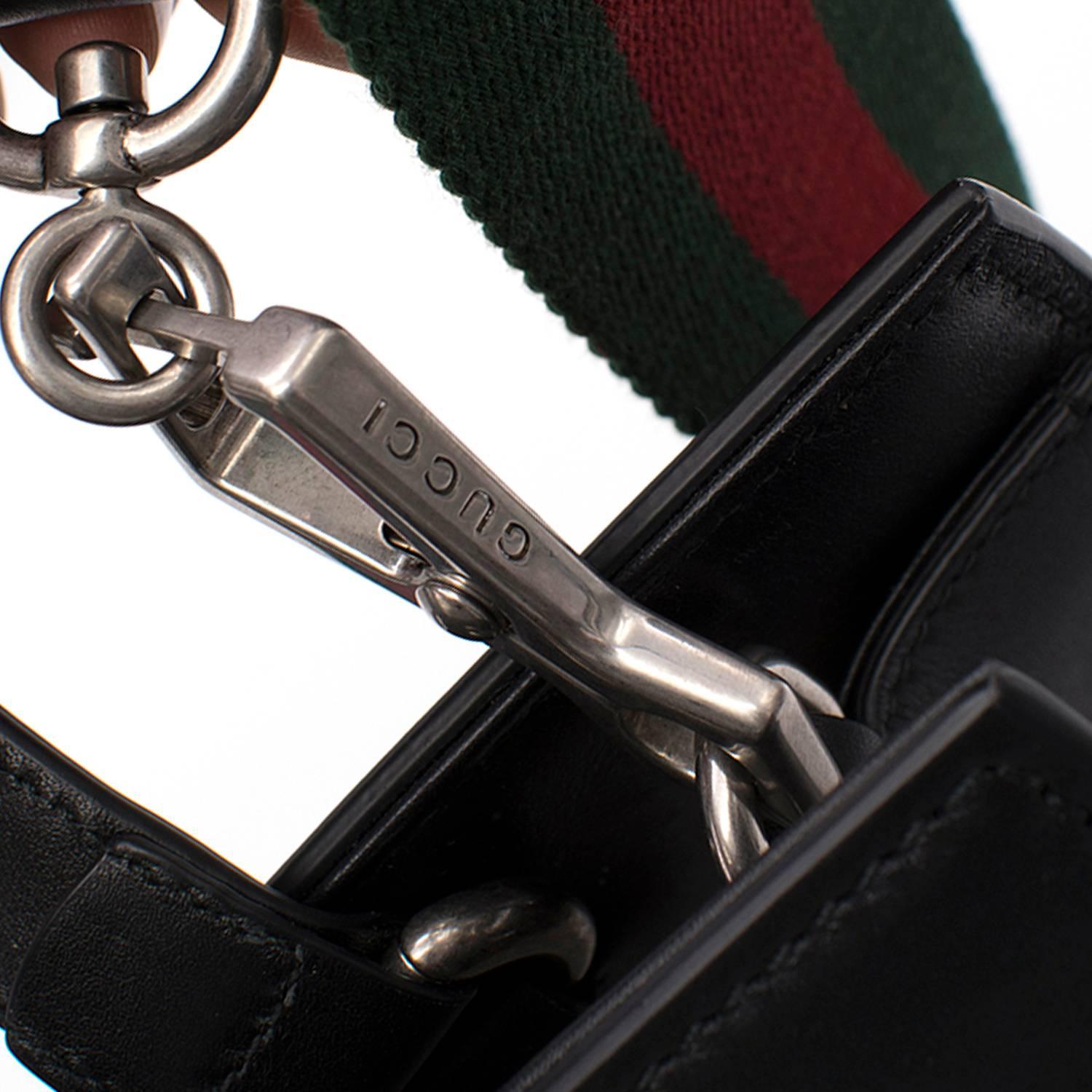 Gucci dionysus black leather top handle bag. 
Made in Italy. 

Top handle. 
Black leather with green/red Web.
Tiger head closure.
Cotton linen lining. 
Features a detachable shoulder strap. 
Interior: Zipped compartment and two card slots. 

Fabric: