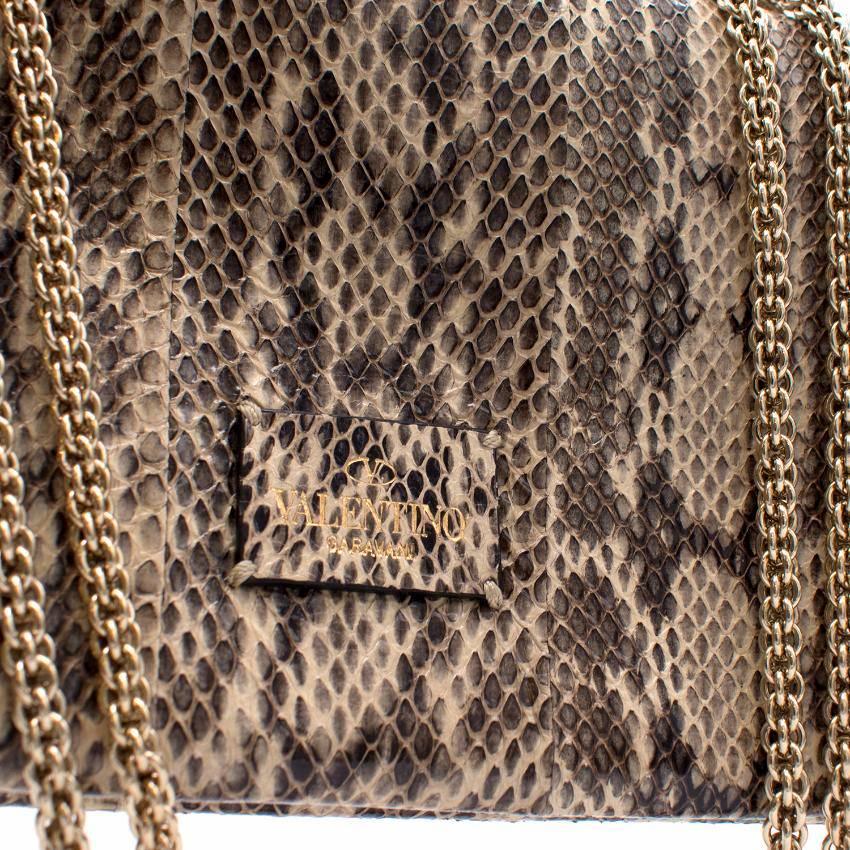 Valentino Rockstud Va Va Voom Python Bag. 

Made in Italy. 
1 internal pocket. 
2 internal compartments.
Front handle with studs.

Approx Measurements: Height: 14.5cm Width: 24cm Handle Drop: Adjustable. 
Fabric: Leather. 
Label Details: Medium Size