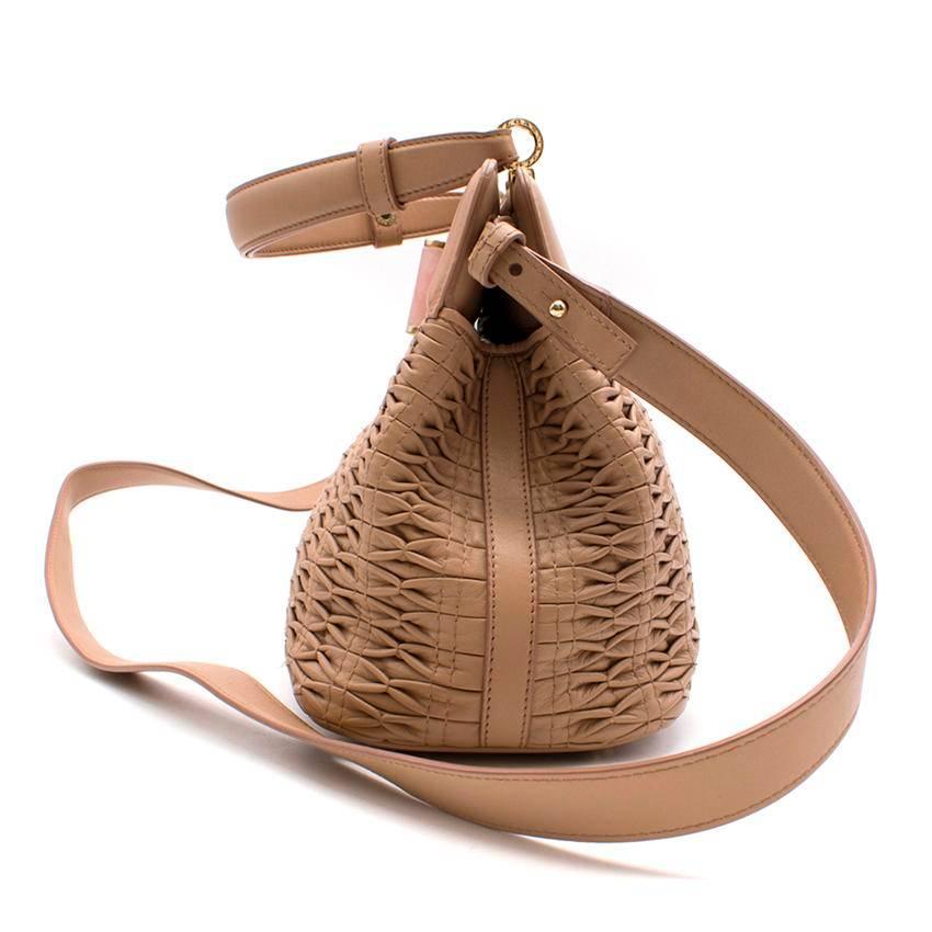 Bvlagari 'Isabella Rossellini' Bag in Nappa Leather.
Bvlgari Isabella Rossellini textured bag. 

Made in Italy. 

Features an interior zipped pocket and two pouches. 

Includes an adjustable shoulder strap and top handle. 

Fabric: Nappa Leather.