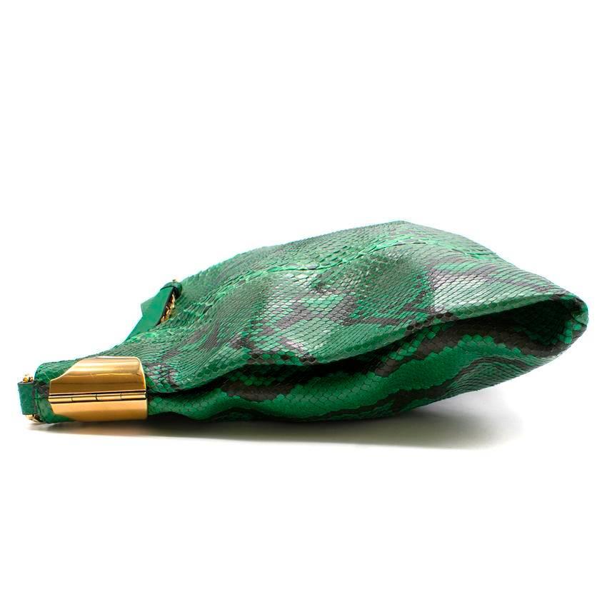 Gucci  green python hobo bag. 
Made in Italy. 
1970 Collection. 

Exotic hobo bag. 
Features side metal corners with engraved â€œgucciâ€ personalization on
brass hardware. 
Gold metal tassel. 
Leather lining. 
Magnet snap closure on top. 
Chain