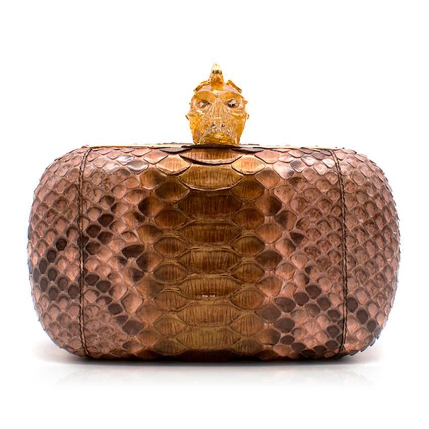 Alexander McQueen Python Box Clutch with Crystal Skull embellishment and clasp. Gold edging with Black Leather lining. 

Fabric: Python. 
 
Approx: 
Width - 20.5 cm 
Length - 13.5 cm
Height - 10 cm 
Depth - 11.5 cm

Condition: 9.5/10. Hardly ever