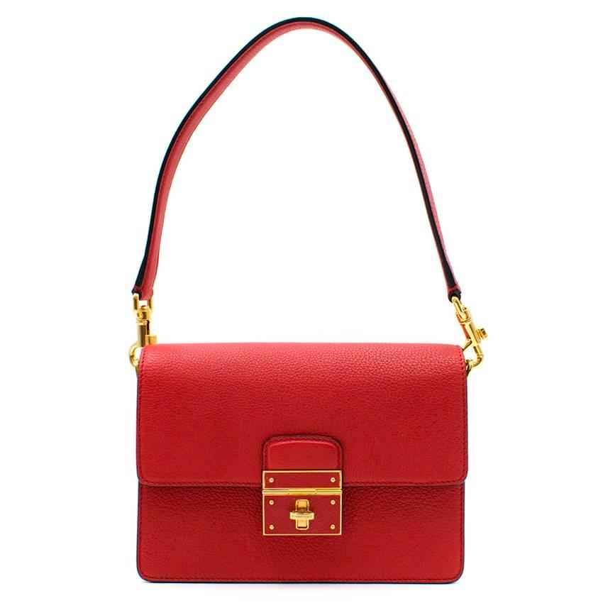 Dolce & Gabbana Red Flap Bag

- Red grained leather 
- Flap style 
- Grained leather buckle with gold-tone hardware
- Gold-tone twist lock embossed with Dolce & Gabbana logo
- Suede lining
- 2 main compartments 
- Interior large zipped compartment
-