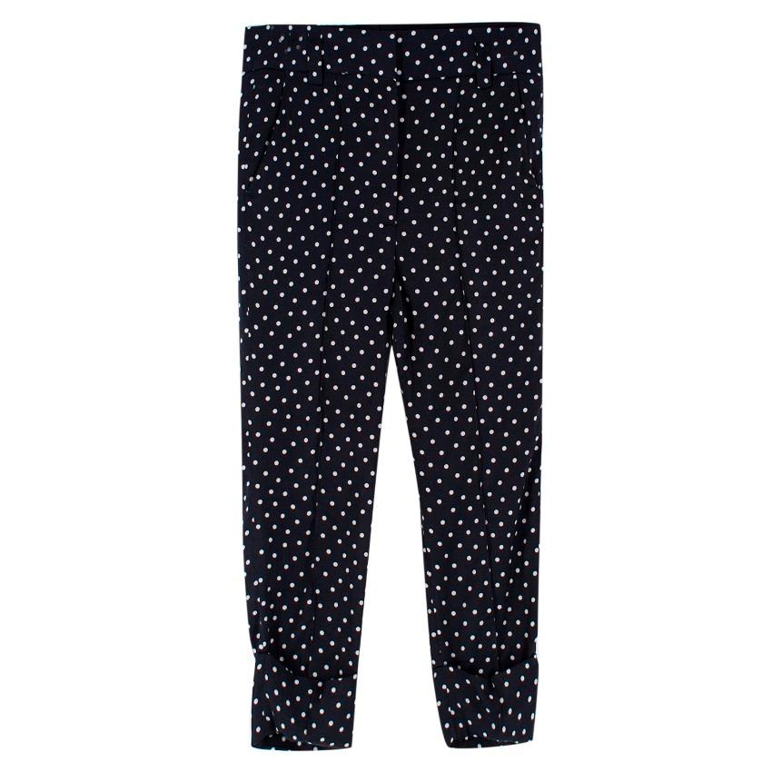 Haider Ackermann Navy Polkadot Trouser and Top Set

Trousers:
-Polkadot trousers with turned up cuffs
-Illusion back pockets
-Zip with hook and eye closure
-Two front pockets

Top:
-Polka dot top with spaghetti straps
-Leather accents on bust
-V