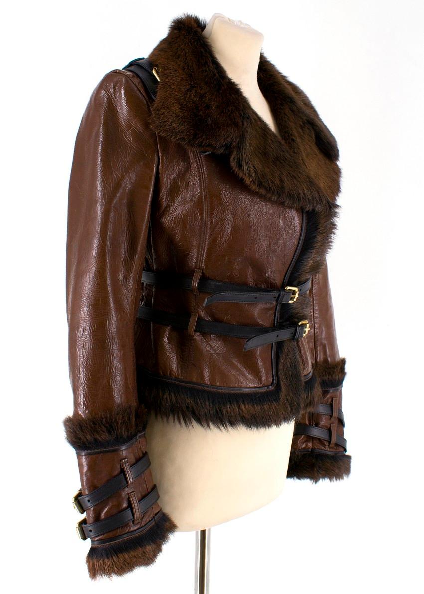 Dsquared2 Fur and Leather Biker Jacket

- Patent brown leather outer
- Sheared fur to the interior and lapels 
- Leather harness detail to the back
- Belted
- Buckles to the cuffs
- Gold-tone hardware 
- Black leather trims

Please note, these items