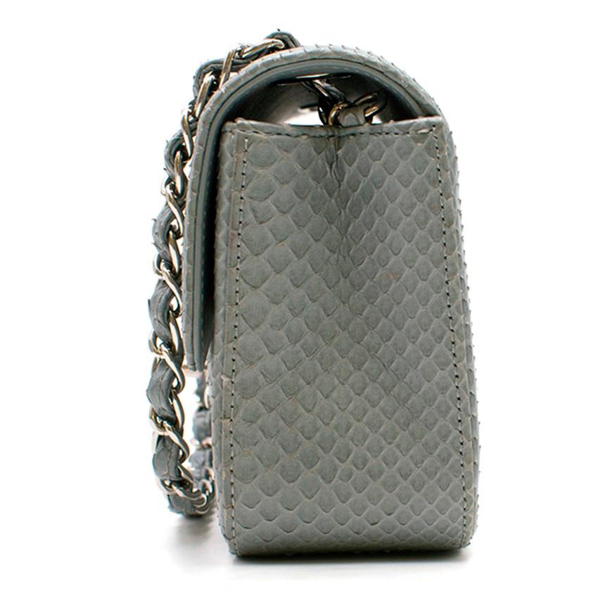 Chanel Grey Python Mini Flap Bag

- Chanel Mini Flap Bag
- Grey python upper and leather
- Silver-tone metal hardware
- Iconic interwoven chain and python shoulder/cross-body strap
- Rear flat slip pocket
- Flap and interlocking CC turnlock