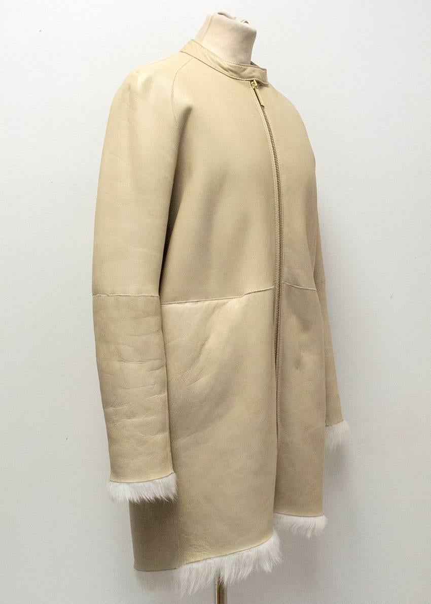 The Row Lambskin Mid-length Coat. Medium weight and very soft to the touch. 
Fur lined and in very good 8/10 condition. Please kindly note, some light signs of wear around the collar, and arms which is only visible upon close inspection, please see