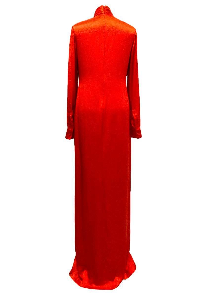 Givenchy red silk gown with a draped layered effect around the high neckline, full length sleeves and a slit up the front of the skirt. 

There are some faint marks on the back of the dress near to the shoulders upon close inspection. 

Condition: