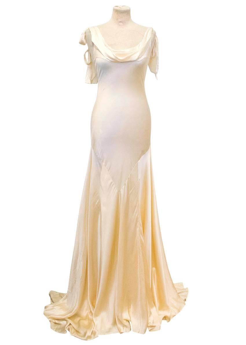 Luisa Beccaria cream silk wedding gown. Features adjustable tied shoulder straps, a draped neckline and a mid-cut back. Fitted down to the hips then flowy and flared.

There are marks on the dress, the majority are at the bottom of the dress. Due