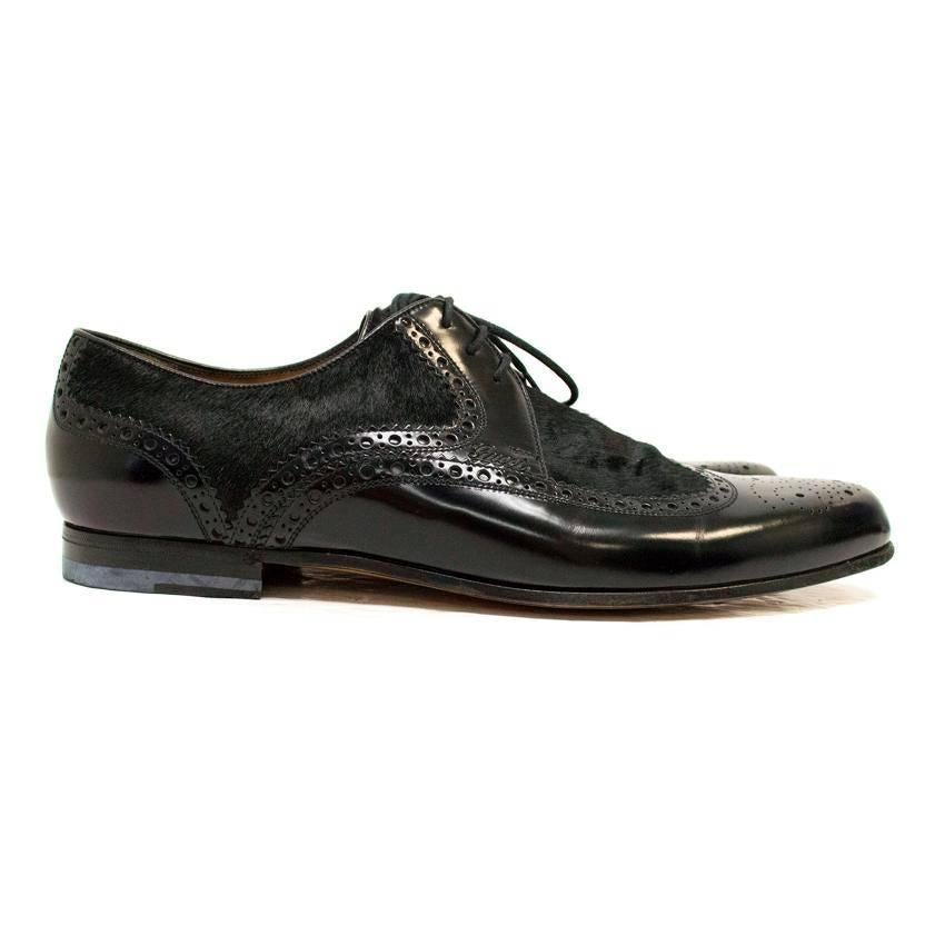 Gucci black shiny leather brogues with a pony hair quarter and upper. They feature a slightly pointed toe, black laces and a black wooden heel.

There are very minor creases and scratches on the leather and minor wear to the soles however, these