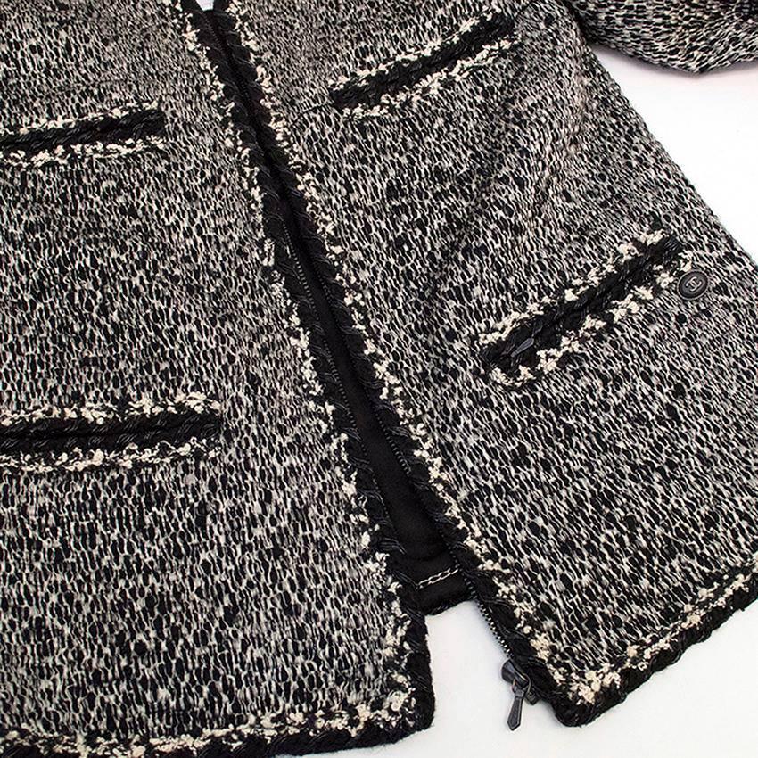 Black and white tweed jacket with silk lining. Zip fastening. Made in France. Professional soft dry cleaning. Great condition, 9.5/10. 

This garment belongs to Caroline Stanbury 'Ladies of London'.

Fabric - Body: 58% Wool, 29% Acrylic, 9%