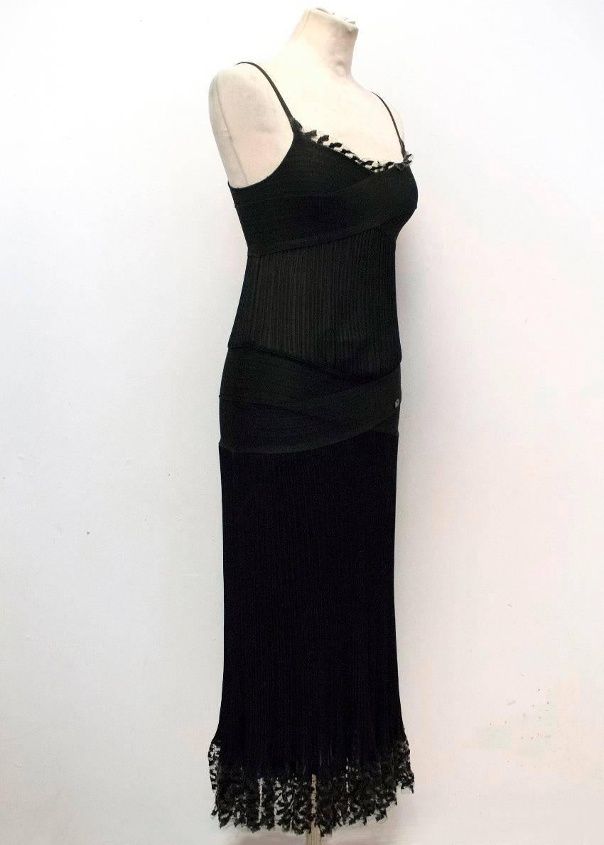 Chanel black, fitted, mid-length dress with thin shoulder straps and a ribbed, semi sheer design. It also features a lace trim on the hem and the neckline. 

Conditions Details : Wear to inside label is the only sign of use to the