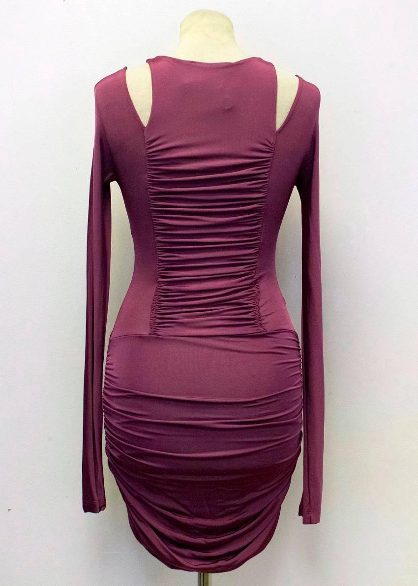 Pierre Balmain purple mini body-con dress with ruching on the sides of the skirt and the front and back of the torso. It features full length sleeves which are cut away at the shoulders, and a crew neckline. 

There are some very tiny pulls on the