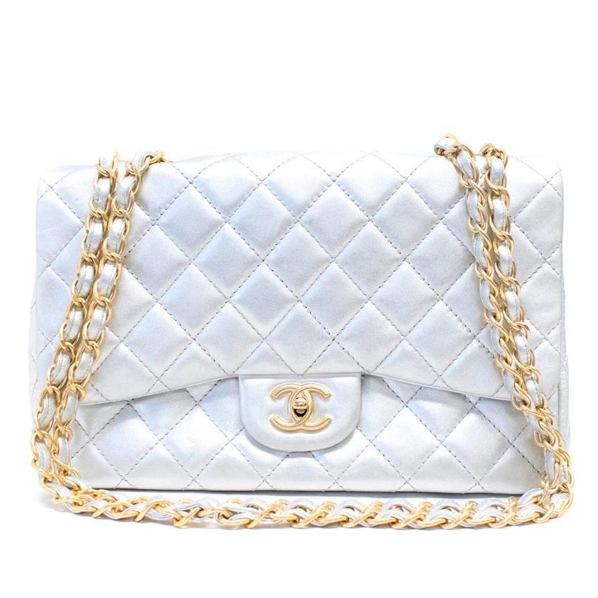 Chanel silver large classic flap bag. This bag features a pocket on the exterior, a pocket on the interior, and a zip pocket on the interior. There is a chain strap the doubles up and a twist lock flap closure. 

Condition: 8.5/10 There are minor