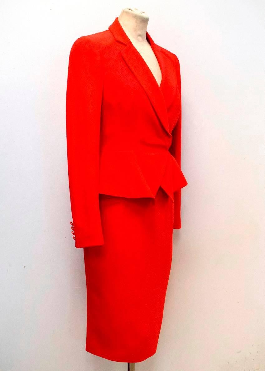 Alexander McQueen red, medium-weight, two piece suit. The blazer is slim fitting with a slight flare at the waist and features, padded shoulders, full length sleeves, peak lapel covered cuff buttons and a covered double breast. The skirt is fitted,