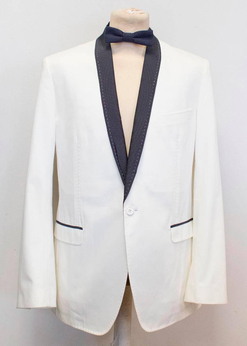 Dolce and Gabbana white dinner jacket with black polka dot lapels featuring:

- a shawl lapel 
- three exterior pockets
- two interior pockets
- one vent
- one front button
- four button cuffs
- partially lined 

Comes with a matching polka bow tie.
