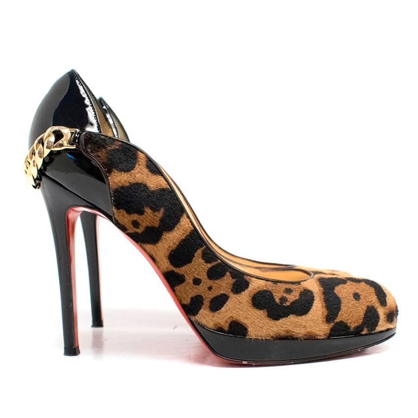 Christian Louboutin Dorepi Calf Hair Pumps. They feature leopard print calf hair, and a black patent leather heel with a gold chain embellishment. 

Conditions Details : Normal wear to the interior of the back to the shoe and the