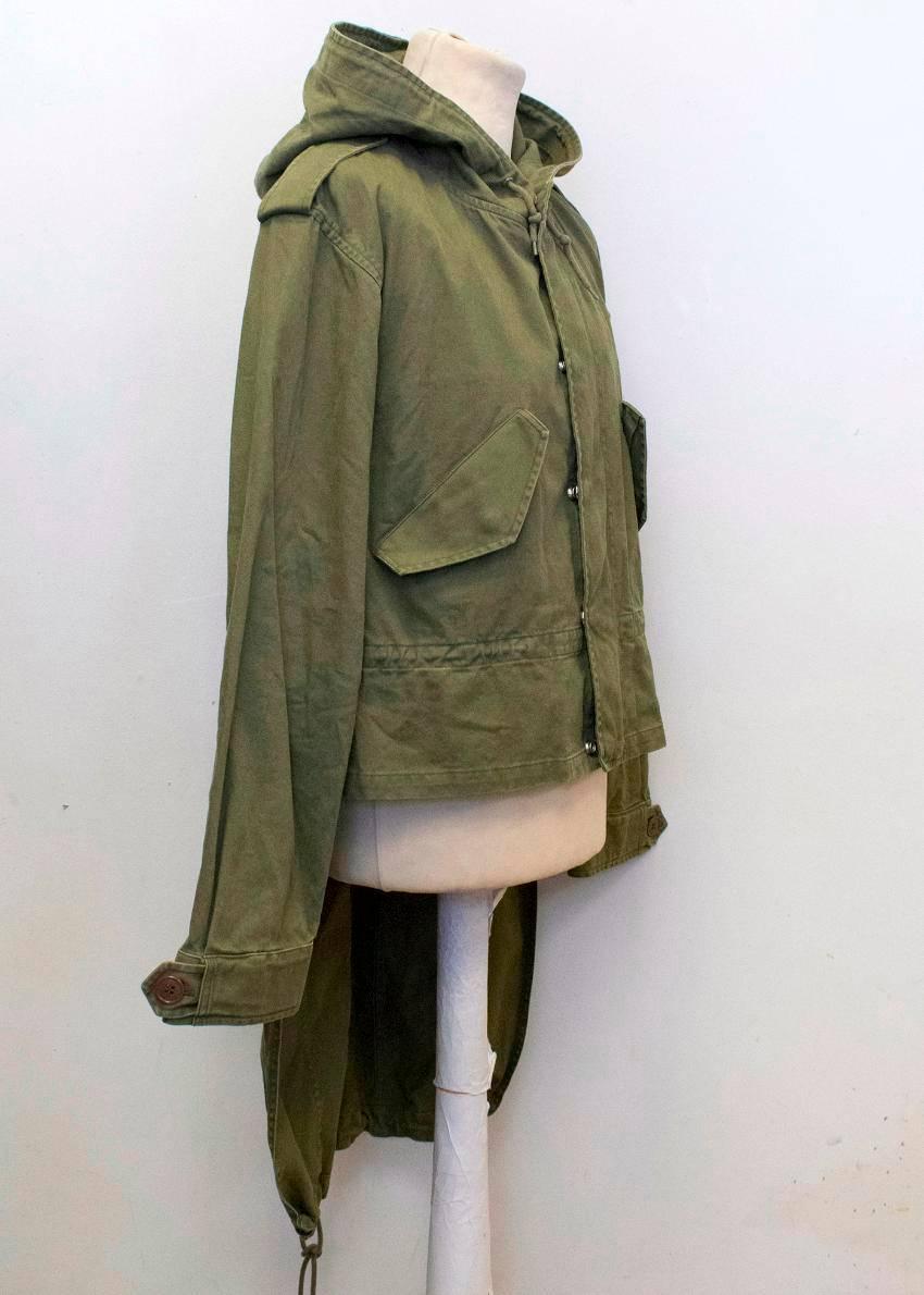 Saint Laurent khaki green lightweight parka coat with a hood and tails. Features two exterior pockets, a string fastening around the waist and silver toned pop out buttons and a concealed zip at the front. 

Condition:10/10 

Size EU: 50
Size UK: