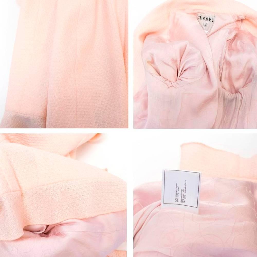 Chanel lightweight, nude pink, lightly textured jacket with a notch lapel, four exterior pockets and ruffled hem and cuffs. Features faux pearl buttons on the cuffs and zips at the front. Made in France.

There are very faint marks around the arm