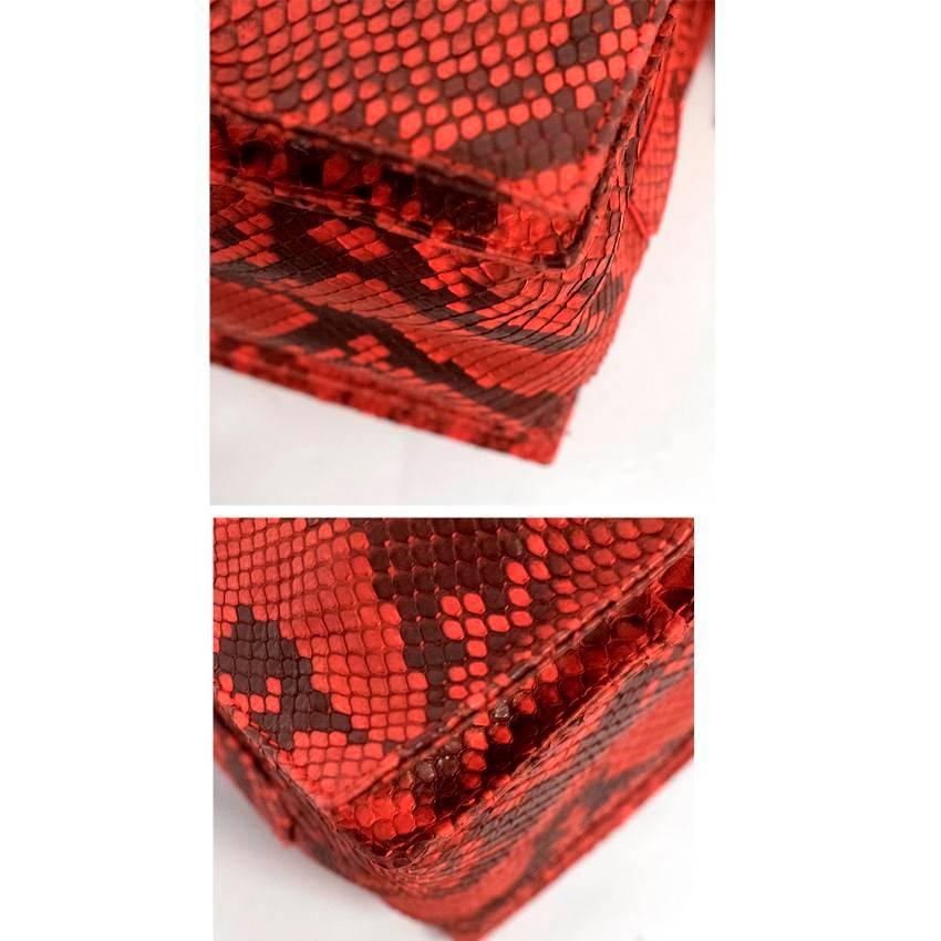 Loewe Red Snakeskin Bag. Features one long strap and two tassel which can be used to adjust the bag. With gold hardware and a three compartment inside, with one side pocket. 

Condition 10/10 

Approx.

Length -27cm 
Width -30cm
Strap -54cm 
Depth