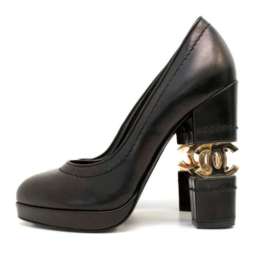 Chanel black leather block heels with CC logo gold hardware built into the heel. Features subtle open stitching. Made famous by Lady GaGa in her 