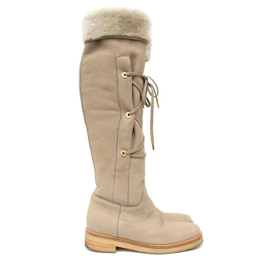 Loro Piana shearling knee-high boots in a flat round-toe style featuring front lace-up decorative detail.

Approx:
Width - 9cm
Length - 26cm
Heel height - 4cm
Boot height (unfolded inc heel) - 57cm

US size 7
UIK size 4