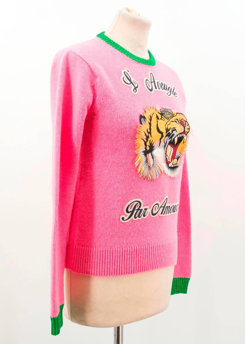 Iconic Gucci bubble- gum pink wool sweater. 
An embroidered, roaring tiger applique with the phrase 