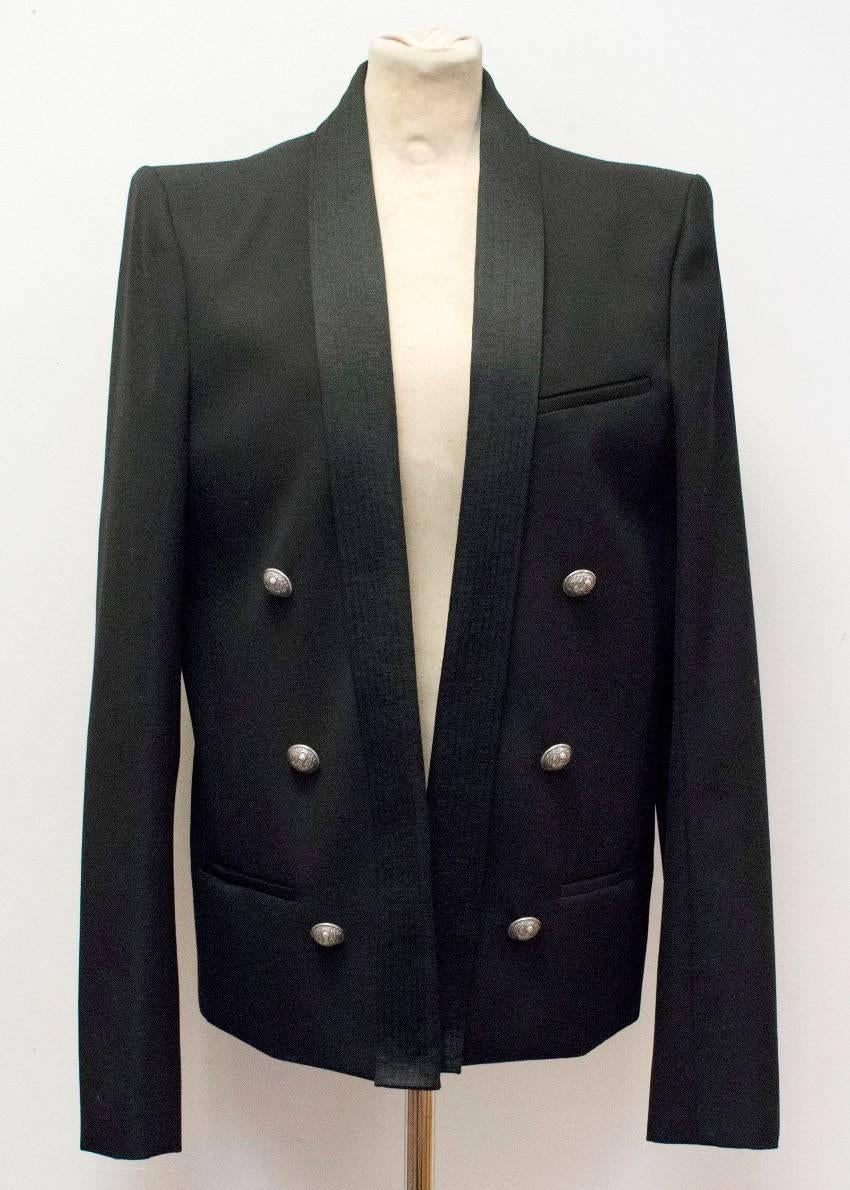 Balmain black blazer jacket, double breasted, shawl lapels and 2 button cuffs. The blazer also features 3 non-functioning pockets, shoulder pads and silver embossed buttons.

Condition: 10/10

Fabric: Body: 100% Wool/ Fabric 2: 57% Cotton/ 43% Silk/