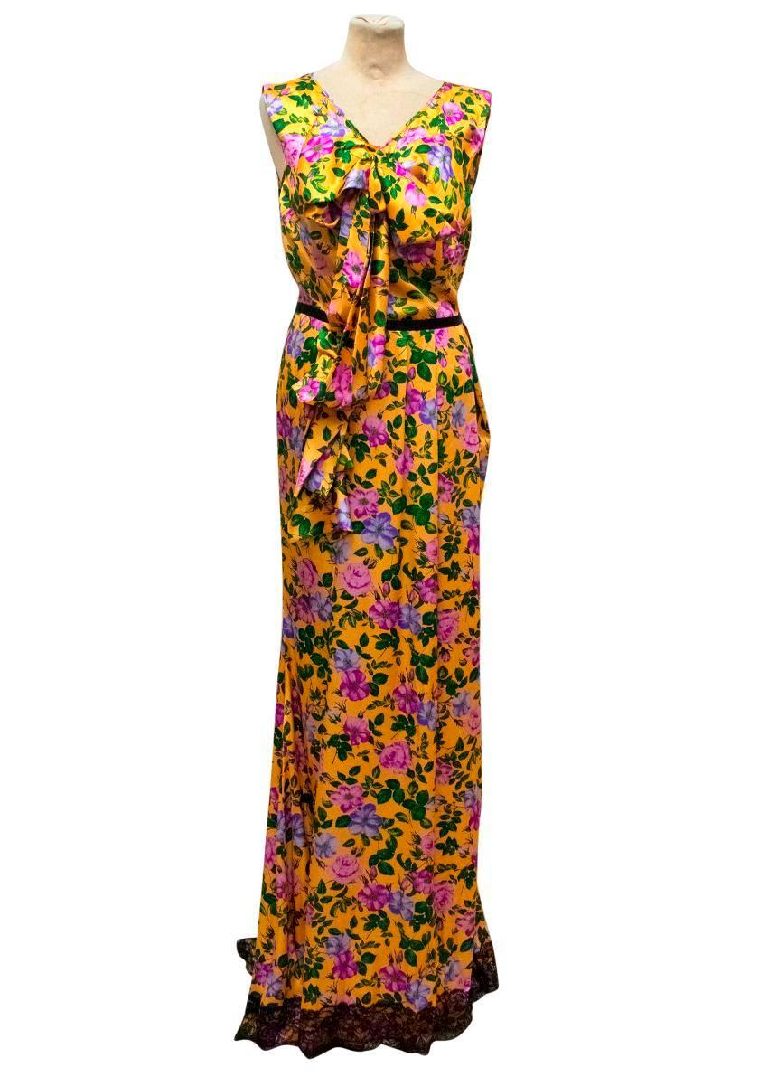 Nina Ricci yellow silk sleeveless gown with a purple and green floral print. It features a v-neckline, a black lace trim on the hem, bow detailing on the chest and a keyhole back.

Condition: 10/10

Fabric: 100% silk 
Approx Measurements: Length: