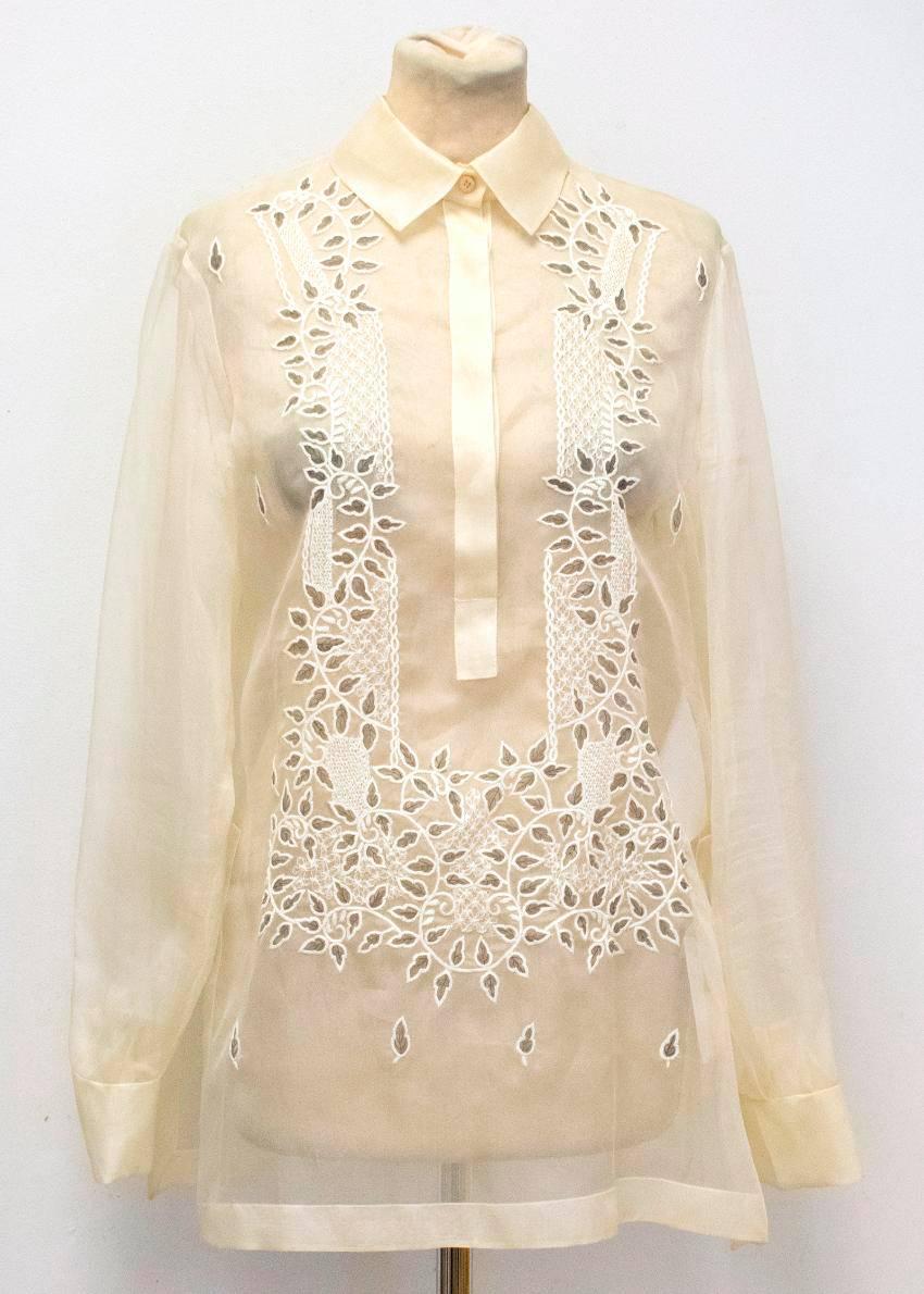 Valentino loose fitting, sheer cream blouse with floral embroidery on the front. It features full length sleeves, a standard collar and buttons down to the mid torso.

Condition: 10/10

Fabric: 100% Silk

Approx Measurements: Length: 71cm,