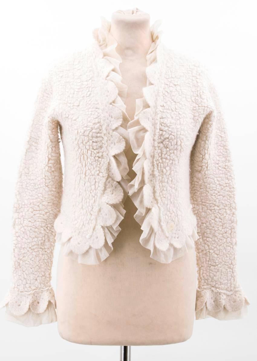 Chanel off-white knit jacket. 

Soft jacket with frill net detailing and inner tie closure in a cropped fit 

Conditions Details : 9/10 

Fabric: 55% Cashmere, 30% Wool, 15% Nylon

Approx Measurements: Bust: 48 Cm, Length: 44 Cm, Sleeve Length: 55