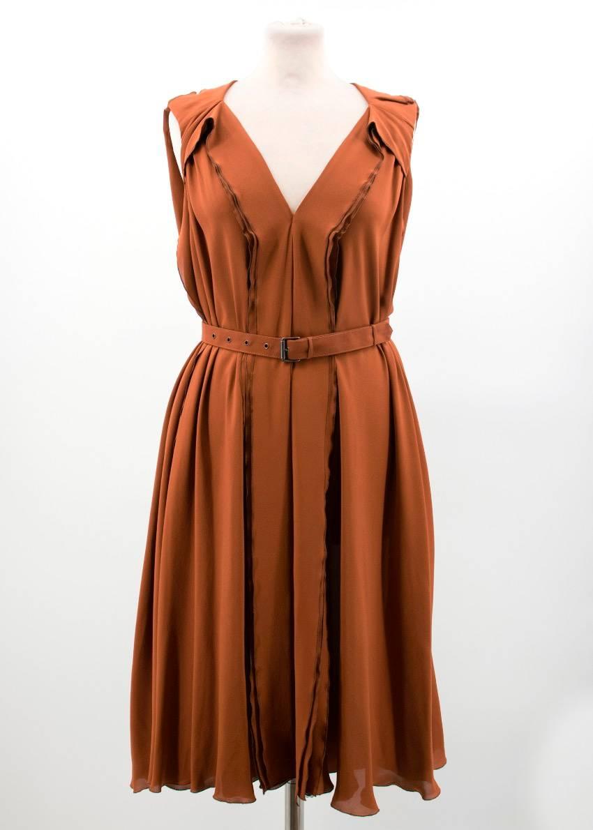 Bottega Veneta burnt orange silk dress. V-neck. Ruffled detail on the neckline and down the center of the body and the sides. Dark grey stitching. Adjustable waist belt with dark metal details. Midi length. Light weight material. 

Conditions